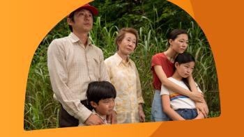 5 people standing in front of grass