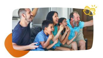 family sitting on couch cheering